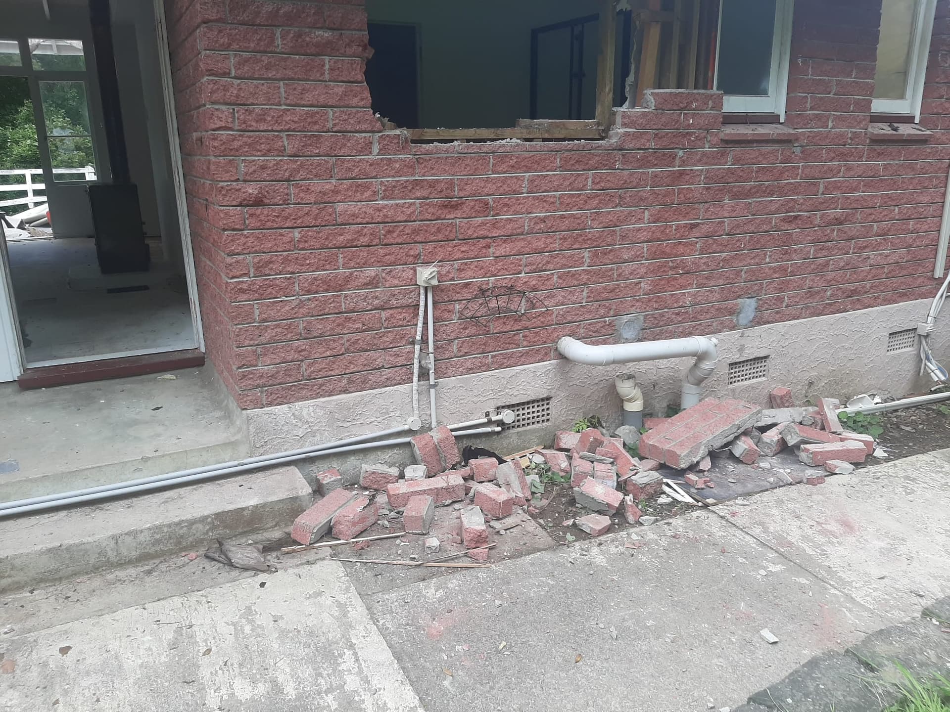 Brick wall demolition with opening cut through and stacked brick rubble - Ambient Civil Auckland