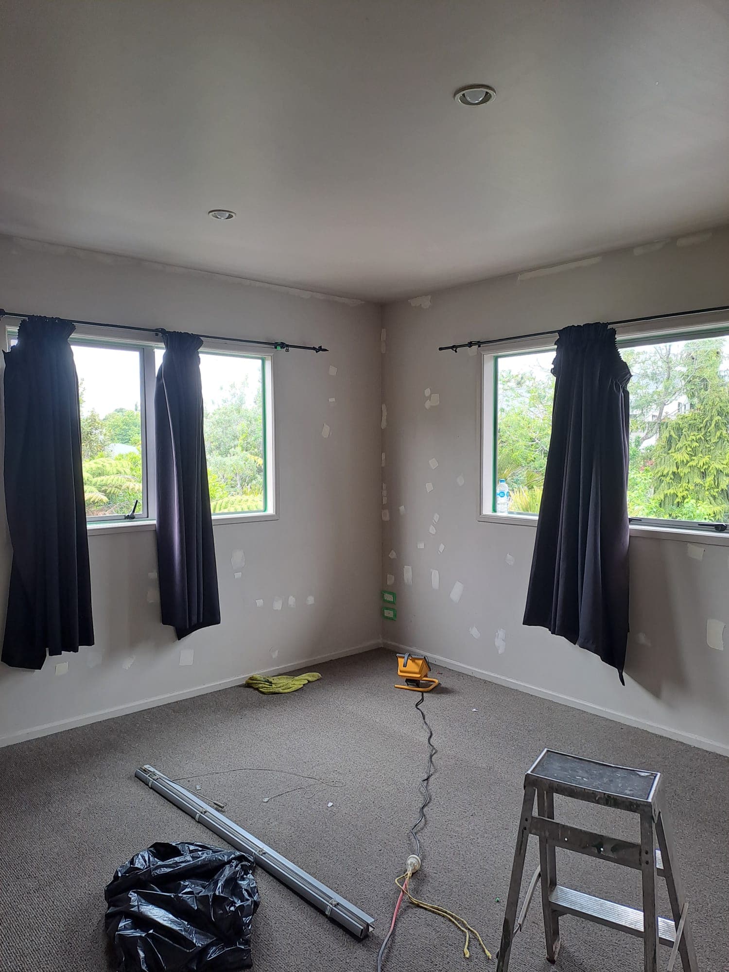 Bedroom interior painting in progress with step ladder and patched walls - Ambient Civil Auckland
