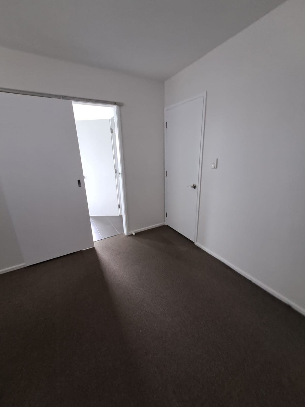 Finished room with crisp white walls and doors after interior painting - Ambient Civil Auckland