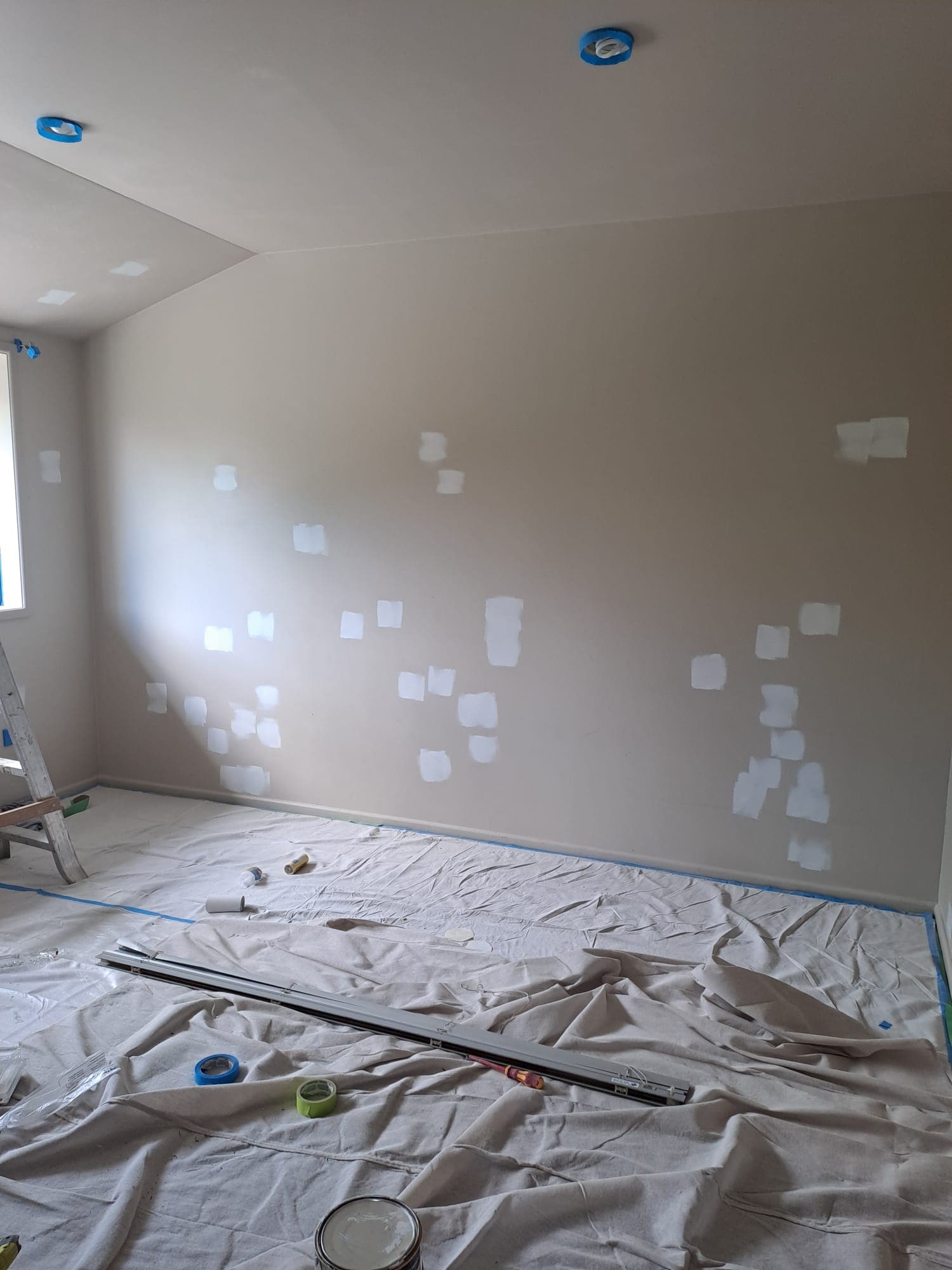 Interior room paint preparation with drop sheets, masking tape and filler patches on walls - Ambient Civil Auckland