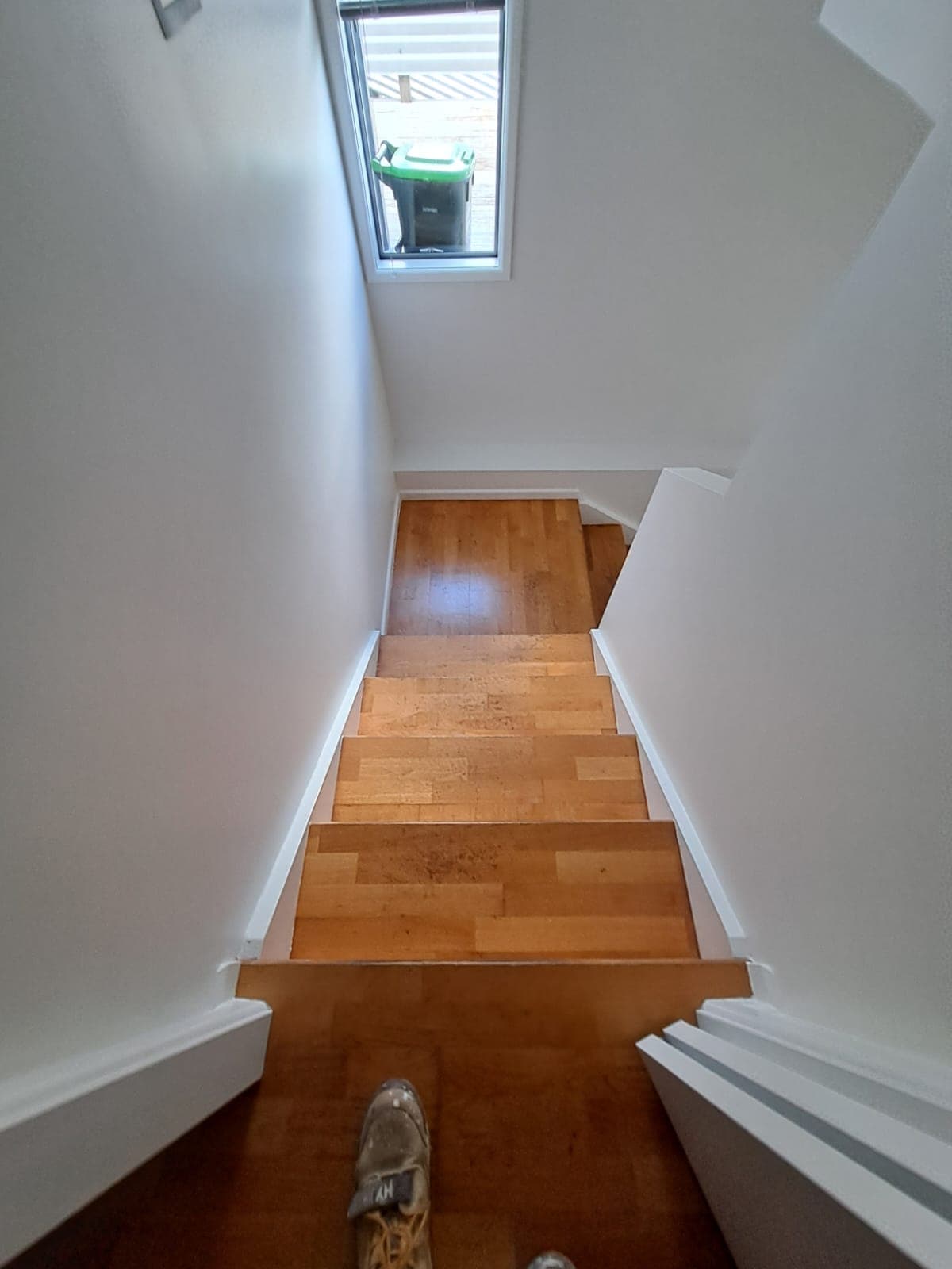 Timber staircase with wood flooring and freshly painted white walls and skirting - Ambient Civil Auckland