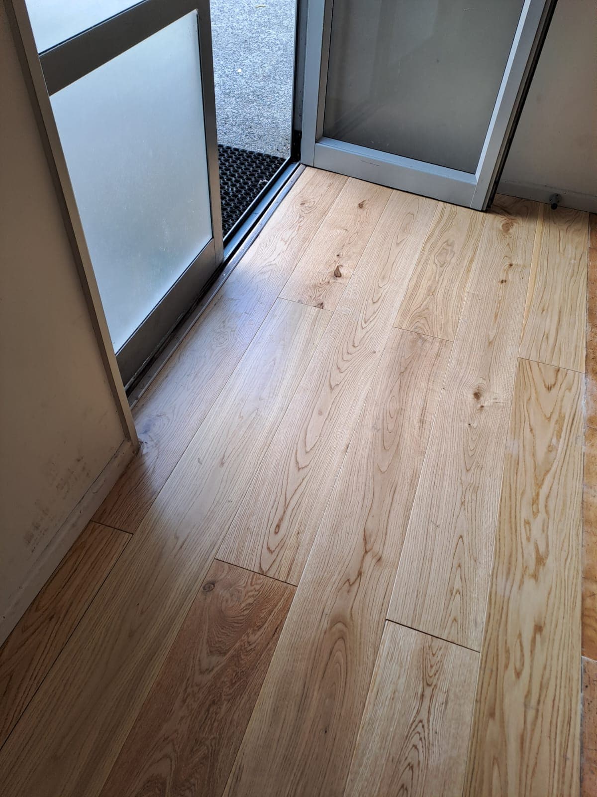 Polished timber floor meeting an aluminium sliding door after interior renovation - Ambient Civil Auckland