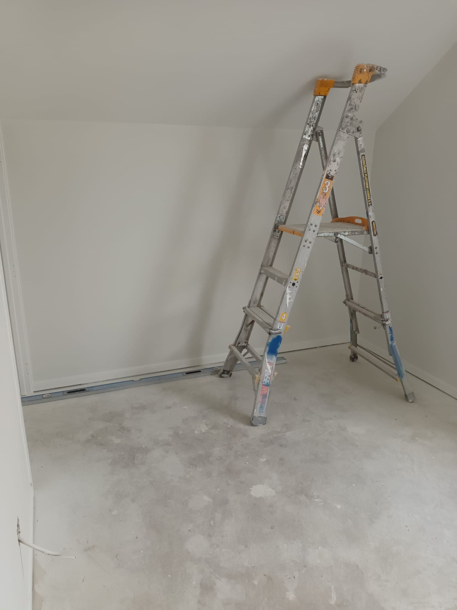 Freshly painted bedroom with platform ladder during interior finishing - Ambient Civil Auckland