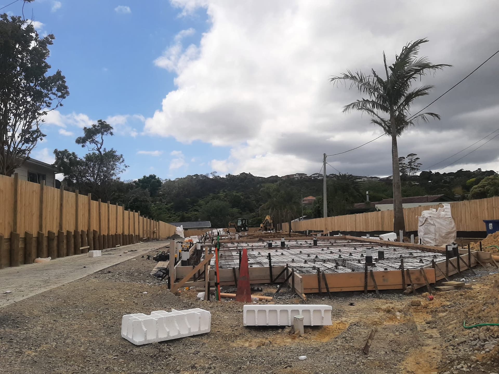 Wide view of rib-raft floor slab formwork and reinforcing across a residential building platform - Ambient Civil Auckland