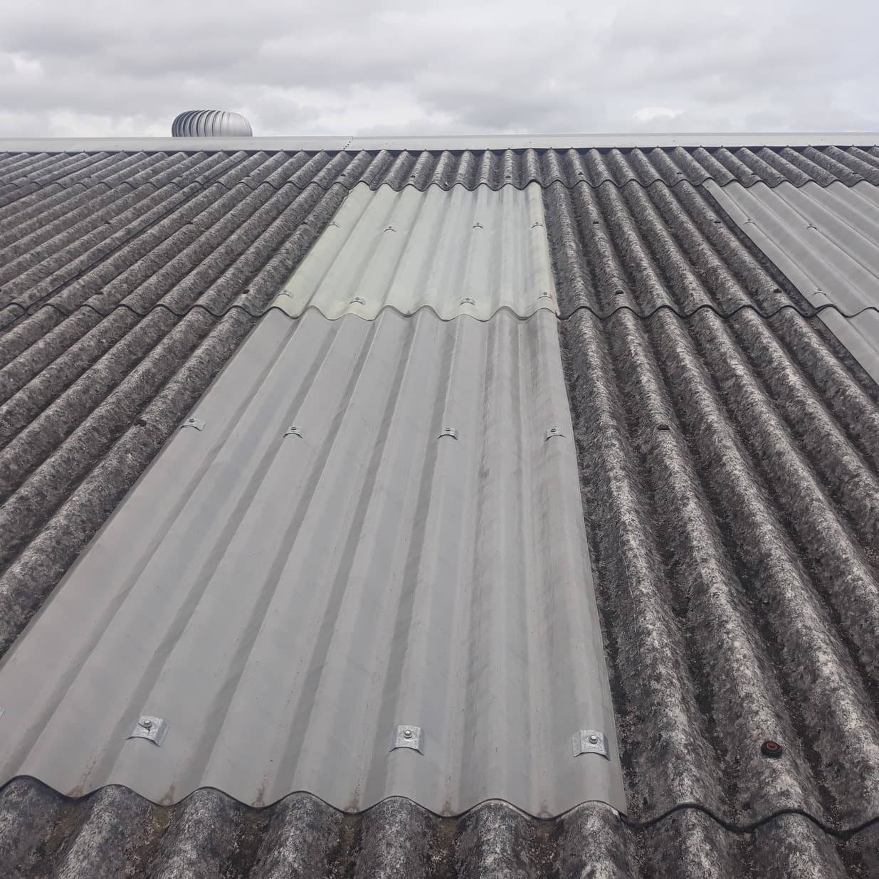 Corrugated asbestos cement roof sheeting being treated - Ambient Civil Auckland