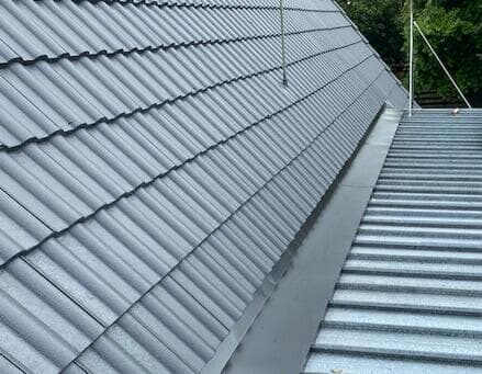 New charcoal tile and metal roof after roof replacement - Ambient Civil Auckland