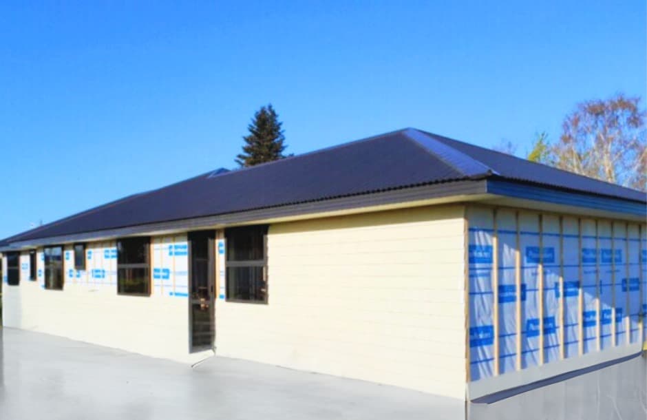 Single-storey building under construction with cladding and new concrete slab - Ambient Civil Auckland