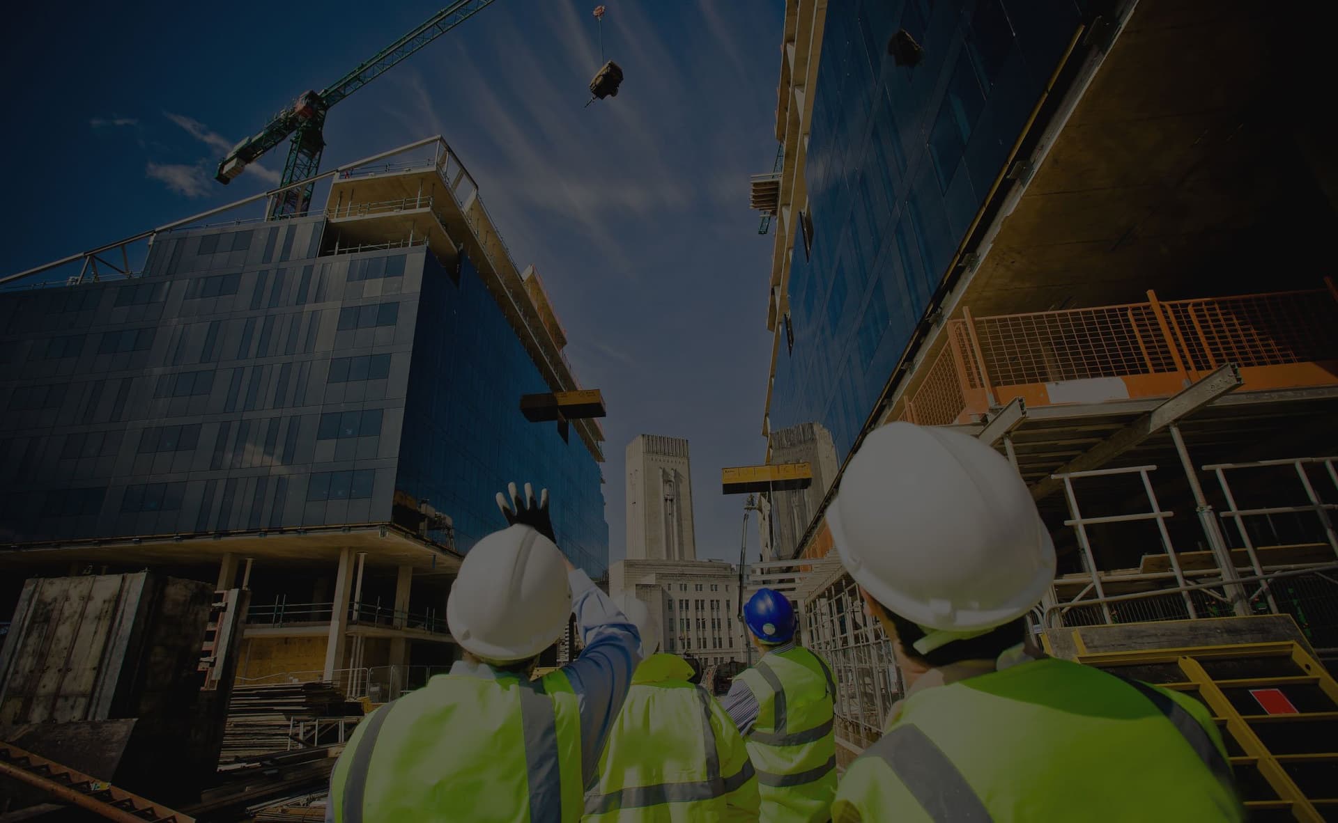 Workers at high-rise construction site with tower crane - Ambient Civil Auckland