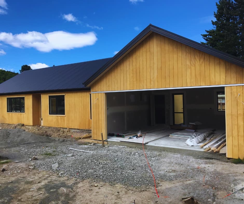 Residential build in progress with timber cladding and gravel groundworks - Ambient Civil Auckland