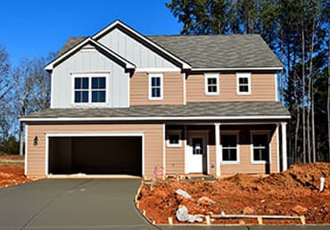 Newly built home with fresh concrete driveway and earthworks - Ambient Civil Auckland