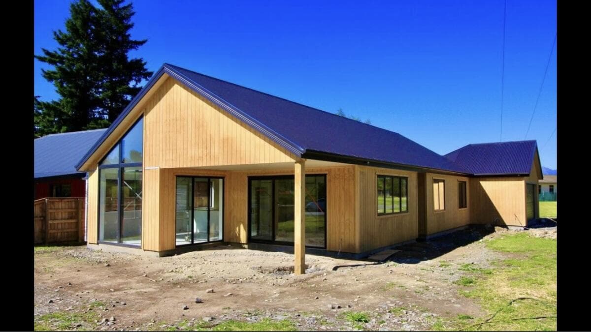 Newly completed timber-clad home with dark metal roof on a prepared Auckland site - Ambient Civil Auckland