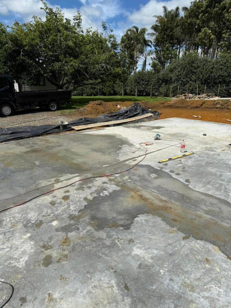 Freshly poured concrete slab being floated and finished on a rural building site - Ambient Civil Auckland