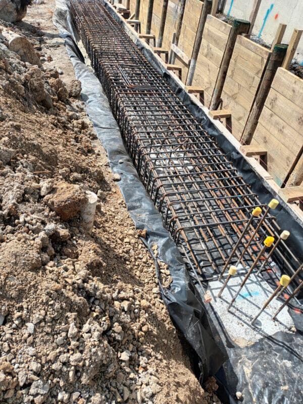 Steel reinforcing cage and timber formwork in a foundation footing - Ambient Civil Auckland