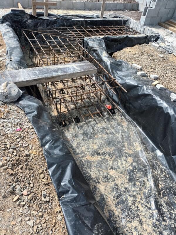 Foundation footing trenches with reinforcing cages and hold-down bolts ready for concrete - Ambient Civil Auckland
