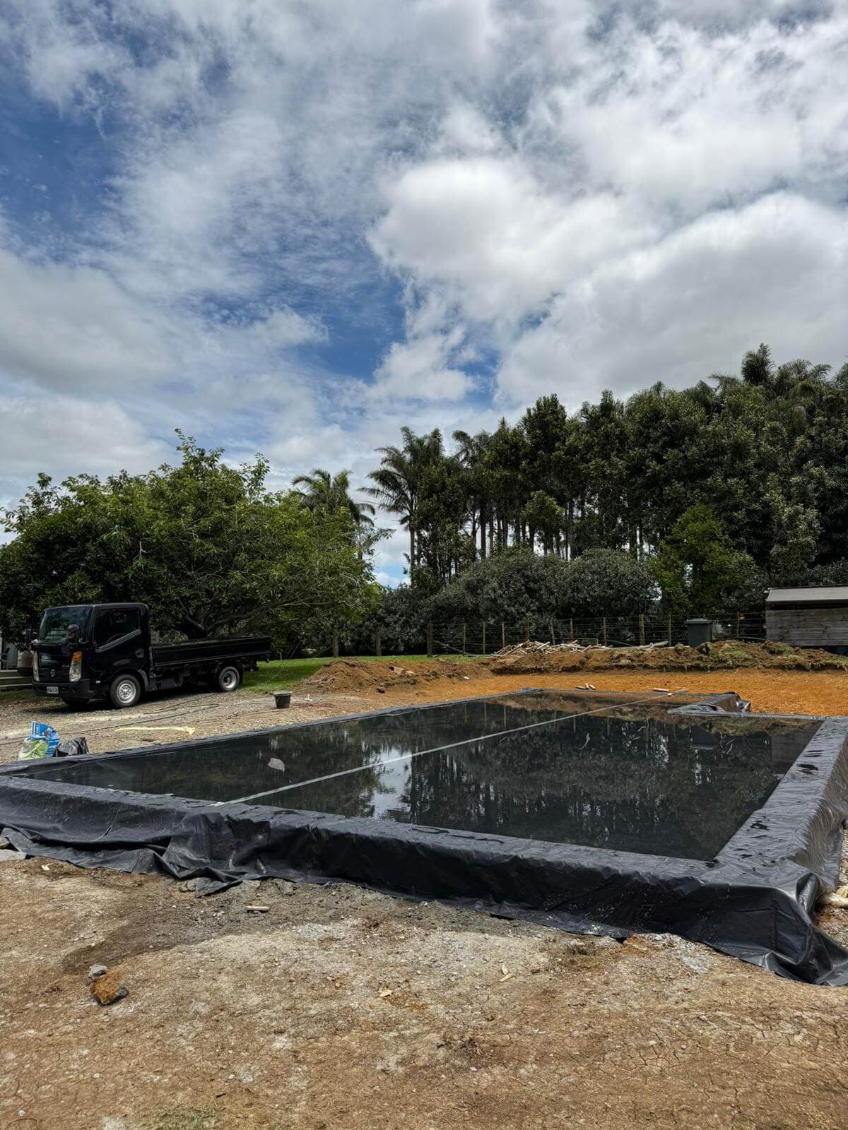 Foundation pad lined with black polythene membrane before a concrete pour - Ambient Civil Auckland