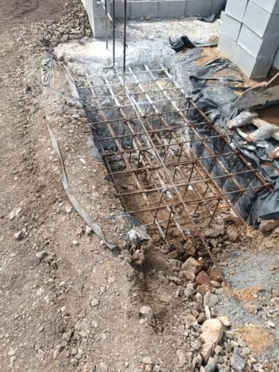 Steel reinforcing mesh in a concrete footing beside blockwork - Ambient Civil Auckland