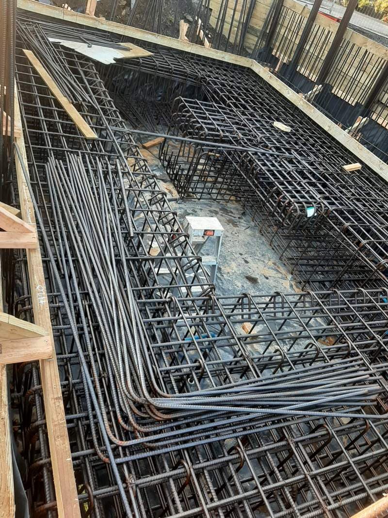 Dense steel rebar reinforcement set in formwork for a concrete foundation pour - Ambient Civil Auckland