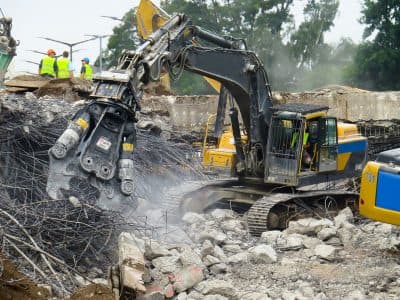 Excavator with shear demolishing concrete and steel - Ambient Civil Auckland