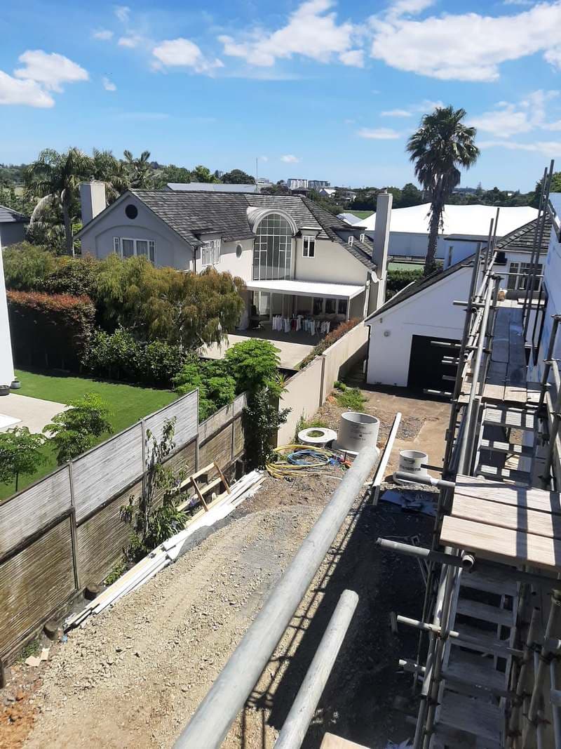 Concrete stormwater pipe and manhole sections staged on a residential site - Ambient Civil Auckland