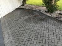 Grey herringbone paver driveway beside garden bed - Ambient Civil Auckland
