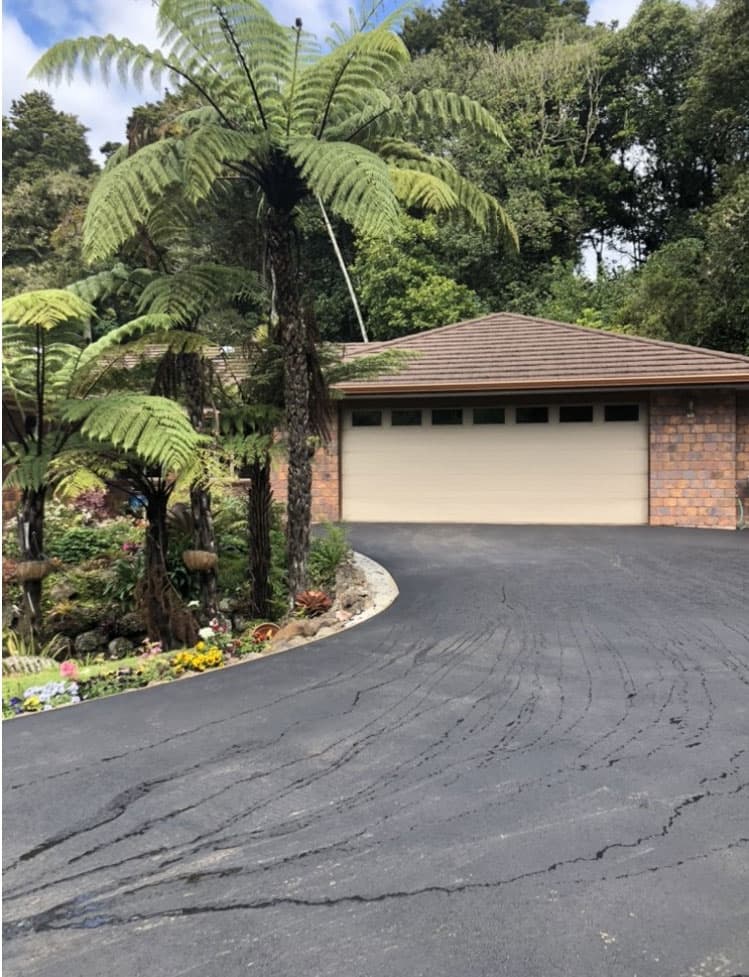 Curved asphalt driveway leading to a residential garage - Ambient Civil Auckland