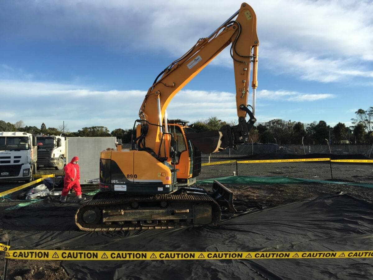 Tracked excavator on a contained Auckland civil works site with caution tape - Ambient Civil Auckland