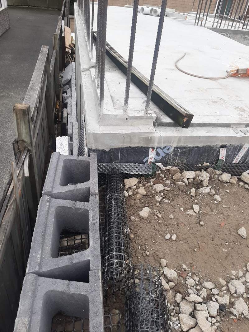 Concrete block retaining wall with geogrid and drainage membrane - Ambient Civil Auckland