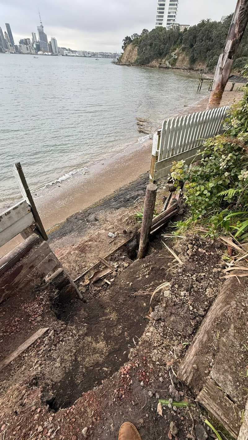 Excavated footings and timber posts for a waterfront retaining wall with Auckland skyline - Ambient Civil Auckland