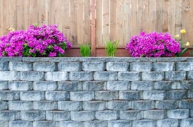 Segmental block retaining wall with timber fence in Auckland - Ambient Civil Auckland
