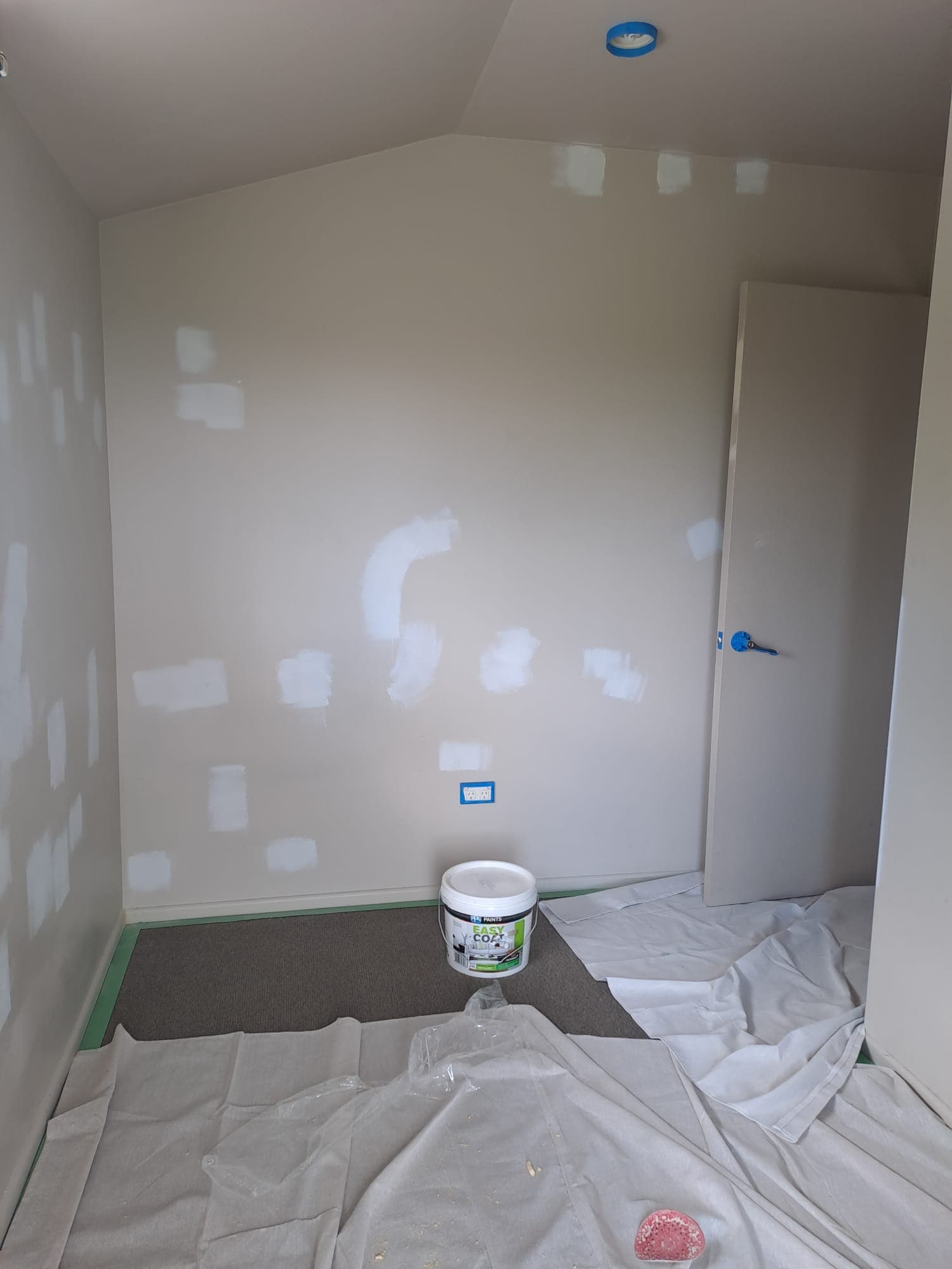 Bedroom walls with plaster filler patches and drop sheets during interior painting prep - Ambient Civil Auckland