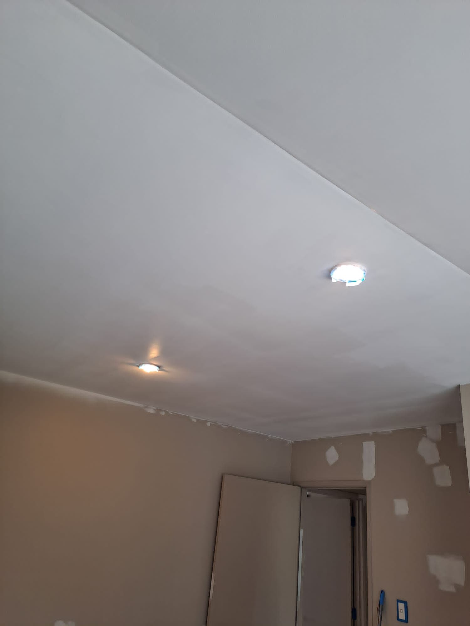 Interior ceiling first coat of white paint with recessed downlights during room repaint - Ambient Civil Auckland
