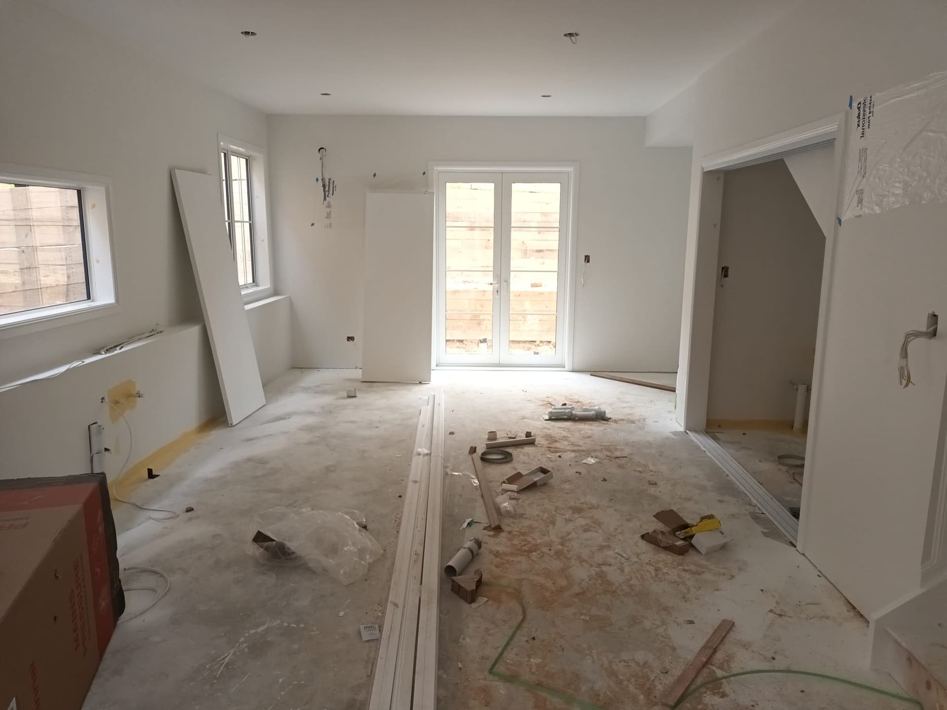 Open-plan living area during plaster and paint finishing in a new-build home - Ambient Civil Auckland
