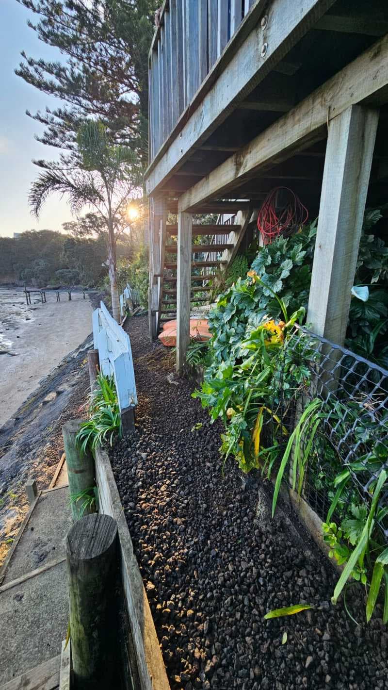 Gravel pathway and timber edging beneath a coastal deck - Ambient Civil Auckland